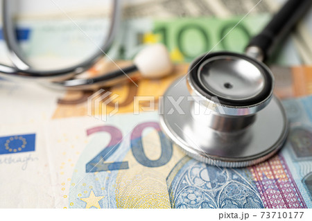 Stethoscope and Euro banknotes on chart or graph paper, Financial, account, statistics and business data medical health concept. Stethoscope and Euro banknotes on chart or graph paper, Financial, account, statistics and business data medical health concept. 73710177