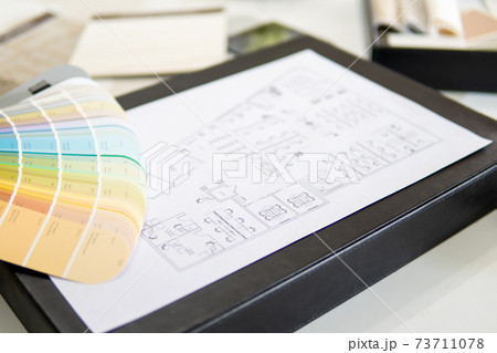 Interior designer's working table, an architectural plan of the house, a color palette. Interior designer's working table, an architectural plan of the house, a color palette. 73711078