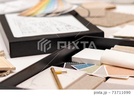 Interior designer's working table, an architectural plan of the house, a color palette. Interior designer's working table, an architectural plan of the house, a color palette. 73711090
