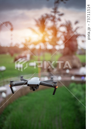 professional drone flying over ancient stone idol monument 73711514