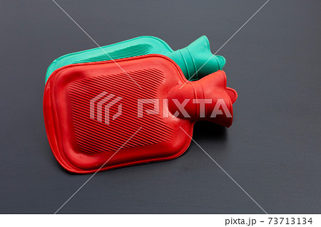 Hot water bags on dark background. 73713134