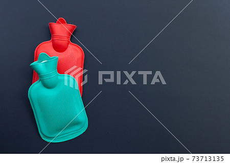 Hot water bags on dark background. Hot water bags on dark background. 73713135