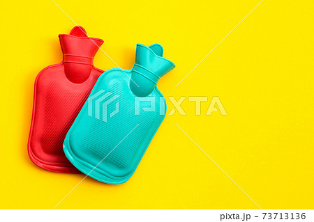 Hot water bags on yellow background. 73713136