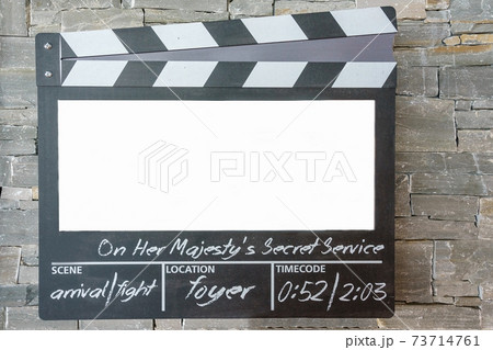 Blank mock up of clapper board,Movie clapper with copy space for your text message or content onstone wall background 73714761