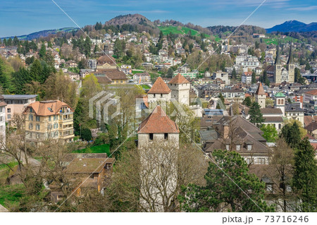 Aerial view of the red tiled roofs of the old town of Lucerne city, wooden Chapel bridge, Reuss river and Lake Lucerne from city wall, Switzerland 73716246