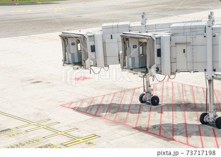 Airplane bridge in airport for passengers boarding or Jetway waiting for a plane to arrive on airport or airport terminal boarding gate. Airplane bridge in airport for passengers boarding or Jetway waiting for a plane to arrive on airport or airport terminal boarding gate. 73717198