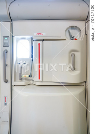 Closeup shot of Emergency exit on an aircraft, view from inside of the plane. Closeup shot of Emergency exit on an aircraft, view from inside of the plane. 73717200