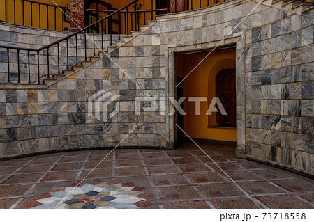 Staircase covered with red carpet in a lobby Staircase covered with red carpet in a lobby 73718558