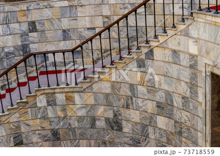 Staircase covered with red carpet in a lobby Staircase covered with red carpet in a lobby 73718559