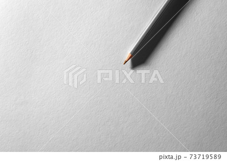 Colored pencil on blank white textured surface. Drawing tools in art studio. Colored pencil on blank white textured surface. Drawing tools in art studio. 73719589