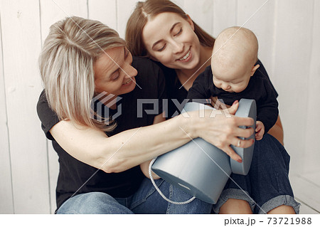 Elegant grandma at home with daughter and grandson Elegant grandma at home with daughter and grandson 73721988
