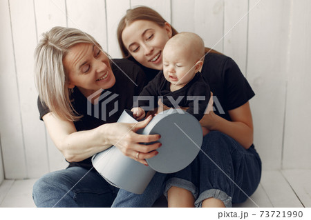 Elegant grandma at home with daughter and grandson 73721990