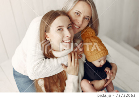 Elegant grandma at home with daughter and grandson Elegant grandma at home with daughter and grandson 73722063