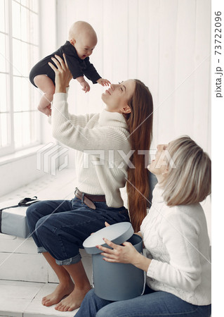 Elegant grandma at home with daughter and granddaughter Elegant grandma at home with daughter and granddaughter 73722096