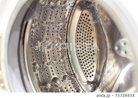 The washing machine drum is dry and clean close-up. Washer The washing machine drum is dry and clean close-up. Washer 73726938