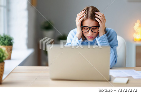 Tired female freelancer working at home 73727272