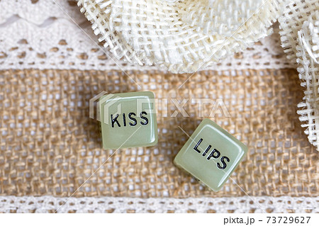 Two erotic dice for sexual game with cotton lace background texture, with the text Kiss lips for Valentines Day,sex,sensual,romantic, love concept Two erotic dice for sexual game with cotton lace background texture, with the text Kiss lips for Valentines Day,sex,sensual,romantic, love concept 73729627