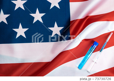 Vaccine vial. Medical syringe with needle for protection flu virus and coronavirus. Covid inoculation usa flag of america. Close up vaccine vial dose flu shot drug needle syringe. 73730726