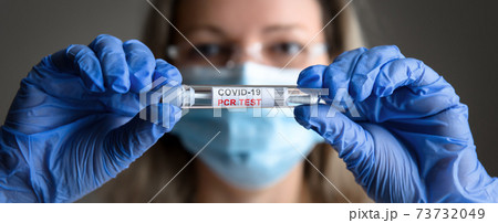 COVID-19 test in doctor hands close-up, woman in medical mask holds tube of coronavirus PCR test COVID-19 test in doctor hands close-up, woman in medical mask holds tube of coronavirus PCR test 73732049