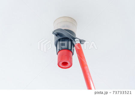Automatic smoke detector fire alarm head on the ceiling. The smoke detector is triggered by a trickle of dum, the red indicator lights up Automatic smoke detector fire alarm head on the ceiling. The smoke detector is triggered by a trickle of dum, the red indicator lights up 73733521