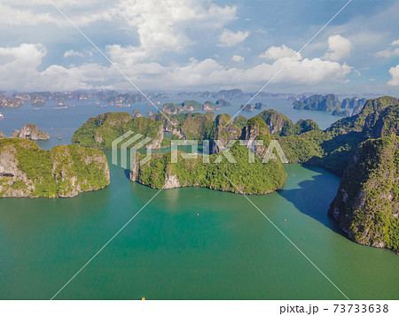 Aerial view panorama of floating fishing village and rock island, Halong Bay, Vietnam, Southeast Asia. UNESCO World Heritage Site. Junk boat cruise to Ha Long Bay. Popular landmark of Vietnam Aerial view panorama of floating fishing village and rock island, Halong Bay, Vietnam, Southeast Asia. UNESCO World Heritage Site. Junk boat cruise to Ha Long Bay. Popular landmark of Vietnam 73733638
