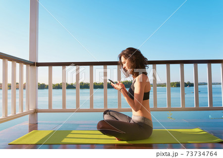 Beautiful young woman doing yoga 73734764