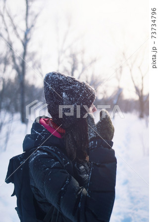 Beautiful woman having fun in snowy forest. Beautiful woman having fun in snowy forest. 73734796