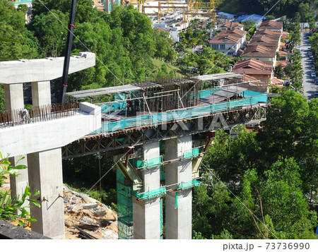 PENANG, MALAYSIA - MARCH 21, 2020: Overhead road under construction. The massive concrete column used to support the concrete road deck. Construction work is in full swing. 73736990