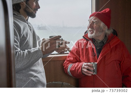 Fishermans discussing work inside of the boat 73739302
