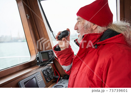 Senior man talking something at the walkie-talkie 73739601