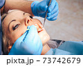 A girl at the reception of a male dentist in a dental chair 73742679