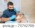 The dentist talks on the phone during the examination  73742700