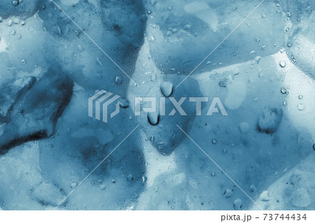 Ice cubes as background texture closeup photo 73744434