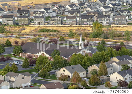 Rooftop view of a church and housing estate 73746569