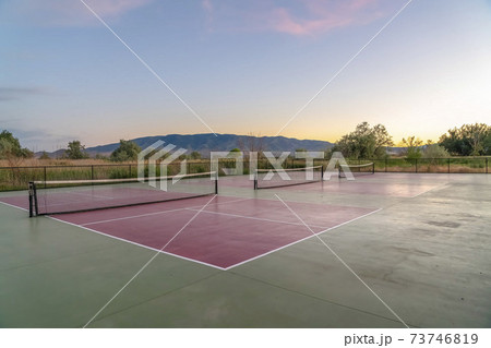 Tennis courts with an amazing view of mountain blue sky and glowing sunset Tennis courts with an amazing view of mountain blue sky and glowing sunset 73746819