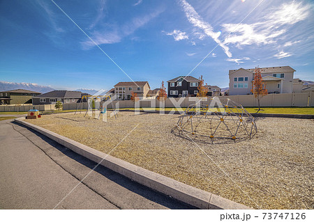 Climbing dome in a kids playground with walkway 73747126