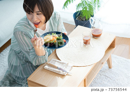 野菜料理を食べる女性 73756544