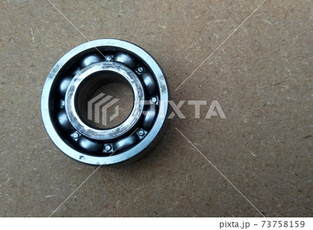 Used bearings, gaskets, screws and some other mechanical components of engines isolated on the high-pressure timber board. Used bearings, gaskets, screws and some other mechanical components of engines isolated on the high-pressure timber board. 73758159