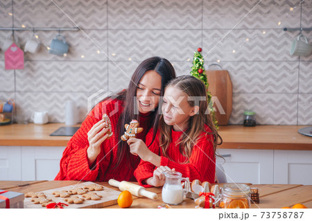 Happy family mother and daughter bake cookies for Christmas 73758787