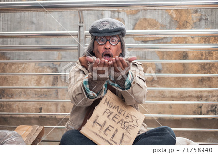 Old homeless beggar showing palm with staring and excited on the bridge 73758940
