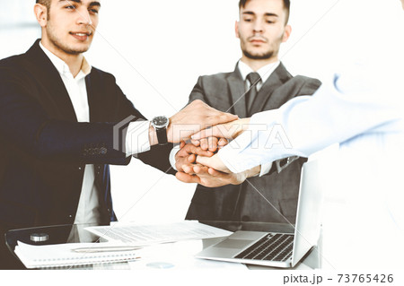 Business people group showing teamwork and joining hands as a circle in modern office. Success concept 73765426
