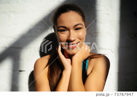 Portrait of beautiful woman. Happy fit girl in sportswear laughing 73767947