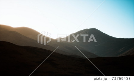 hills with rocks at sunset 73769453