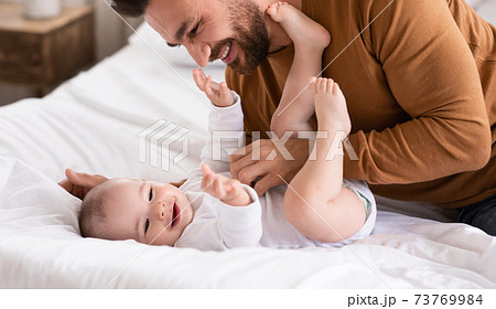 Happy Father And Little Baby Playing Together Bonding At Home 73769984