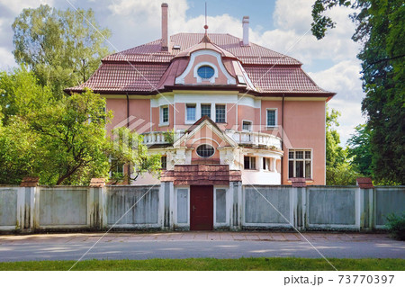 Old german mansion behind the fence in Kaliningrad Old german mansion behind the fence in Kaliningrad 73770397