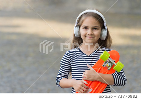 Enjoy your vacation. Happy child hold penny board 73770982