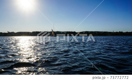 Sunny crusing in Egypt Nile river with fellucca boat yacht bright blue sky 73772772
