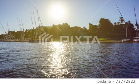 Sunny crusing in Egypt Nile river with fellucca boat yacht bright blue sky 73772822