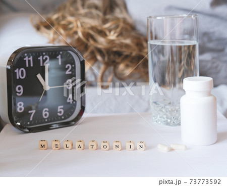 beautiful curly haired woman laying in bed. healthy sleep concept. beautiful curly haired woman laying in bed. healthy sleep concept. 73773592