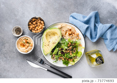 Vegetarian salad with chickpea hummus, greens and avocado Vegetarian salad with chickpea hummus, greens and avocado 73774693